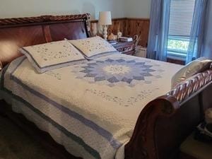 bedroom featuring wooden walls