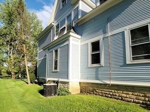 view of property exterior featuring a yard and cooling unit
