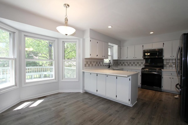 1960 Slippery Rock Rd, Naperville, IL 60565 - kitchen featuring black range with gas stovetop, stainless steel microwave, freestanding refrigerator, decorative backsplash, and recessed lighting