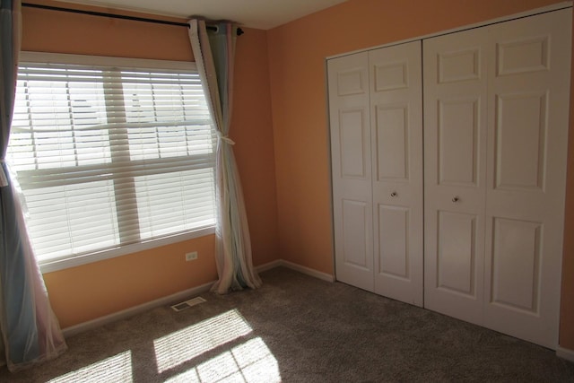 164 Blue Heron Ct, Round Lake, IL 60073 - unfurnished bedroom featuring carpet flooring, a closet, and baseboards
