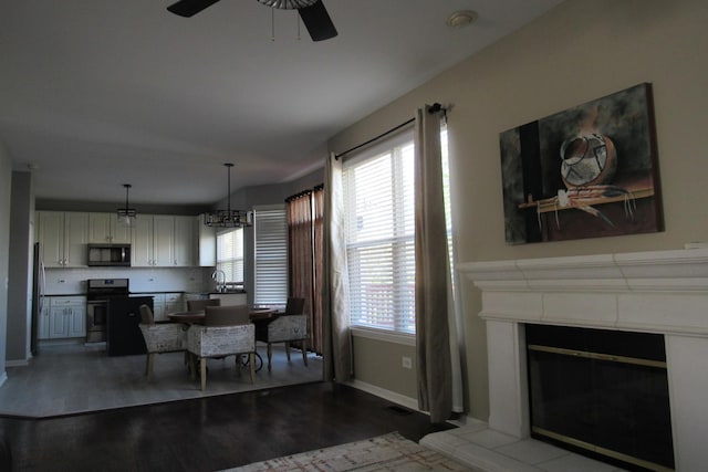 164 Blue Heron Ct, Round Lake, IL 60073 - dining area with wood finished floors, ceiling fan, baseboards, and a fireplace