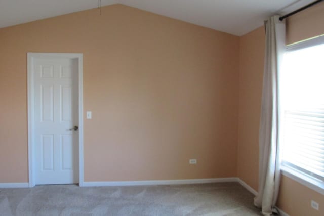 164 Blue Heron Ct, Round Lake, IL 60073 - unfurnished room with light carpet, vaulted ceiling, and baseboards