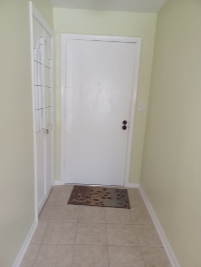 70 Old Oak Dr Unit 226, Buffalo Grove, IL 60089 - doorway to outside featuring light tile patterned flooring and baseboards