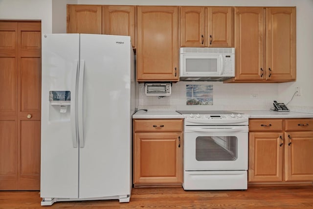 kitchen featuring white appliances, light wood-style flooring, light countertops, and decorative backsplash