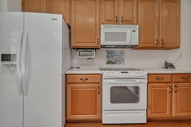 kitchen with white appliances, light countertops, decorative backsplash, and light wood-style floors