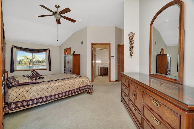 bedroom with vaulted ceiling, light carpet, arched walkways, and ensuite bathroom