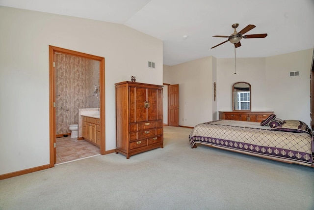 bedroom featuring baseboards, light colored carpet, ensuite bath, high vaulted ceiling, and a ceiling fan