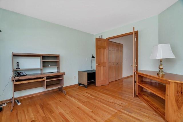 office with light wood-type flooring and baseboards