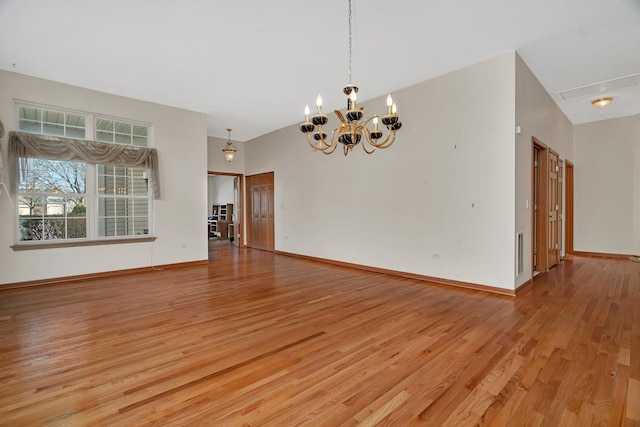 unfurnished room featuring light wood finished floors, a chandelier, and baseboards