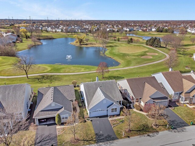 aerial perspective of suburban area featuring a nearby body of water and a local golf course