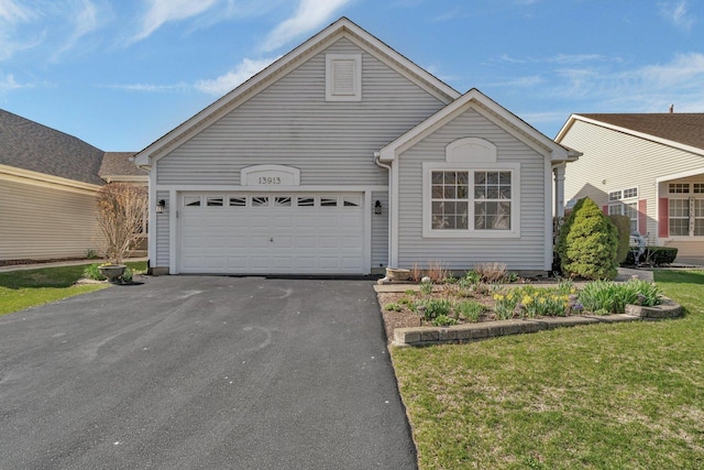 view of front of property with asphalt driveway, an attached garage, and a front lawn