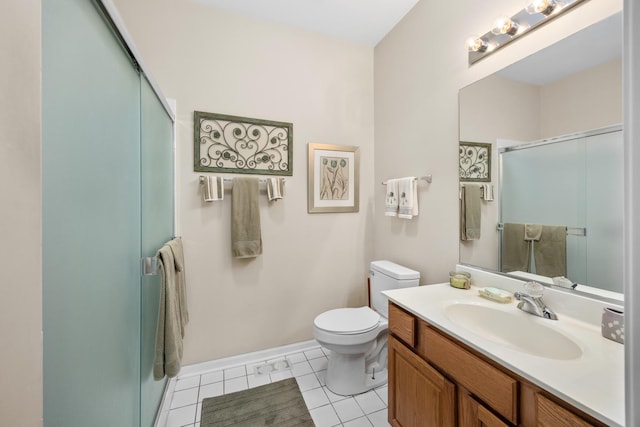 bathroom with toilet, a shower with shower door, vanity, baseboards, and tile patterned floors