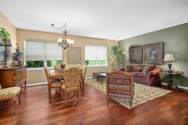 dining room with a chandelier, plenty of natural light, baseboards, and wood finished floors