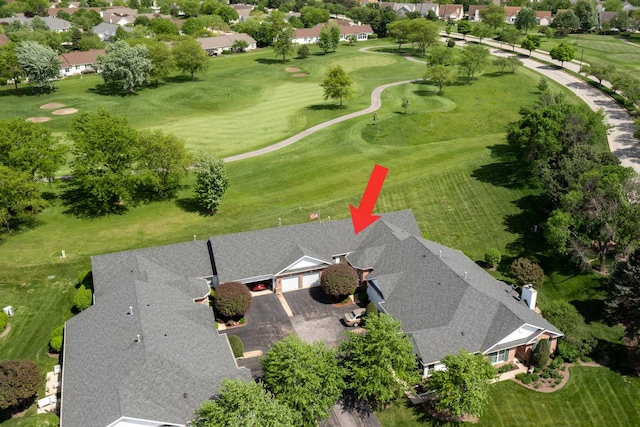 aerial view of residential area featuring a golf course