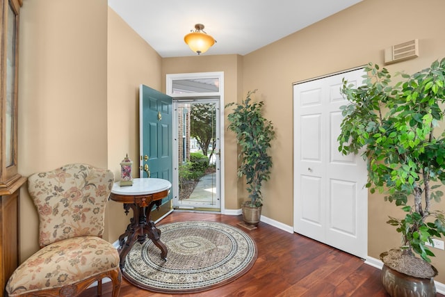 foyer with wood finished floors and baseboards