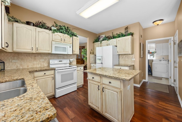kitchen with white appliances, washer / dryer, tasteful backsplash, dark wood-style flooring, and a kitchen island