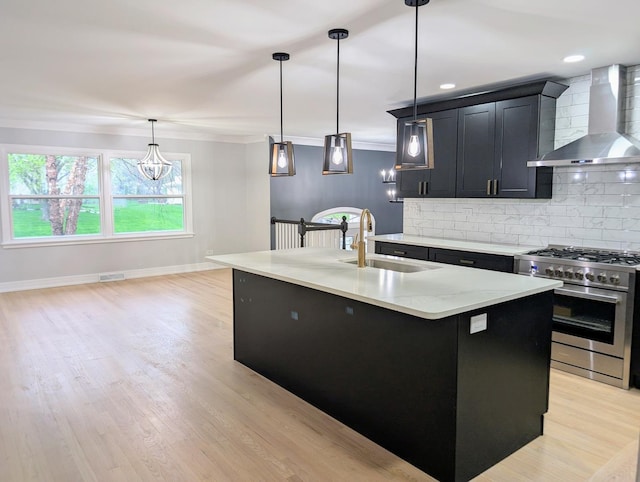 27W075 Fleming Dr, Winfield, IL 60190 - kitchen with wall chimney range hood, stainless steel gas range, a sink, dark cabinets, and crown molding