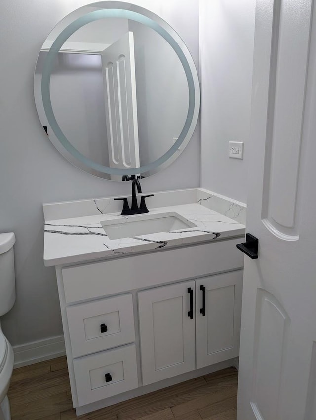 27W075 Fleming Dr, Winfield, IL 60190 - half bath featuring toilet, wood finished floors, vanity, and baseboards