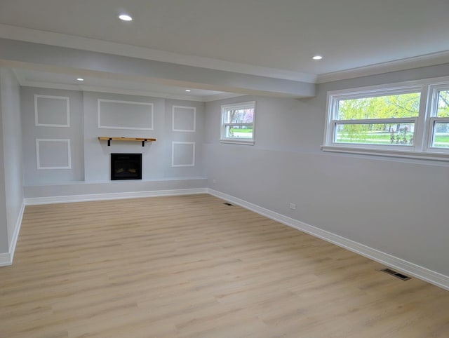 27W075 Fleming Dr, Winfield, IL 60190 - below grade area featuring baseboards, light wood-type flooring, a fireplace with raised hearth, and recessed lighting
