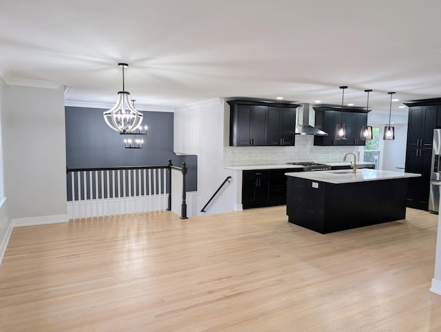 27W075 Fleming Dr, Winfield, IL 60190 - kitchen featuring wall chimney range hood, dark cabinets, light countertops, backsplash, and light wood-style flooring