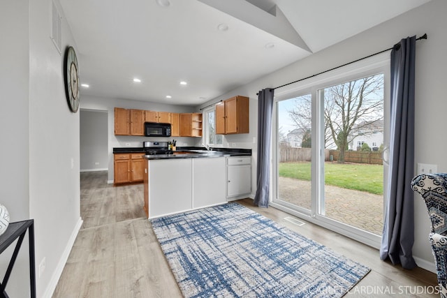 327 Persimmon Ln, Oswego, IL 60543 - kitchen with black microwave, stainless steel range with gas stovetop, dark countertops, light wood-style floors, and a sink