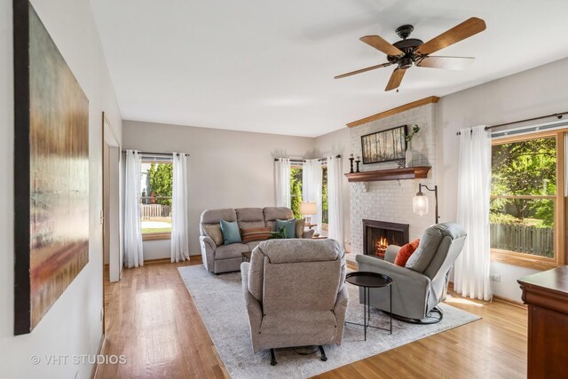 551 Salceda Ln, Mundelein, IL 60060 - living room with a brick fireplace, wood finished floors, and a ceiling fan