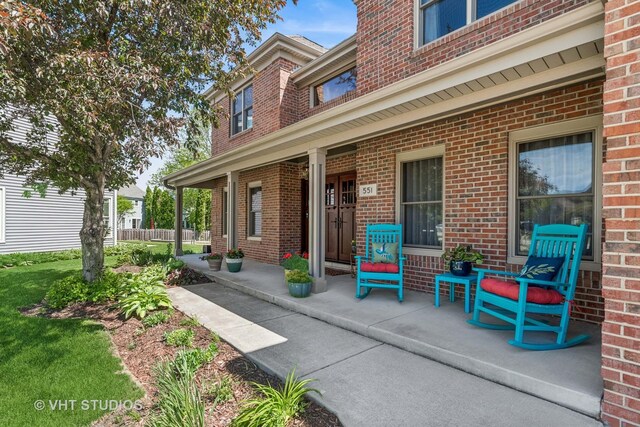 551 Salceda Ln, Mundelein, IL 60060 - property entrance featuring brick siding and a porch