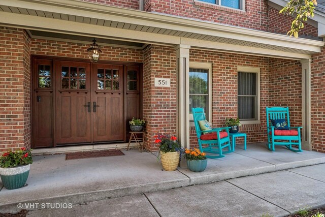551 Salceda Ln, Mundelein, IL 60060 - doorway to property featuring brick siding and a porch
