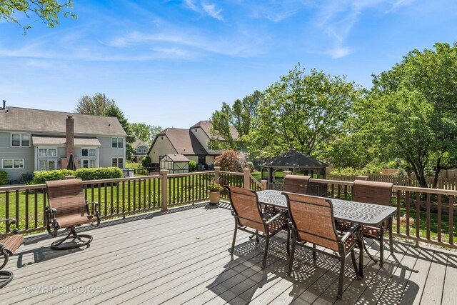 551 Salceda Ln, Mundelein, IL 60060 - deck featuring outdoor dining area, a storage shed, a residential view, and an outbuilding