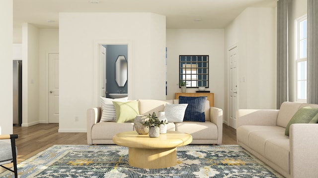 living room featuring healthy amount of natural light, wood finished floors, and baseboards