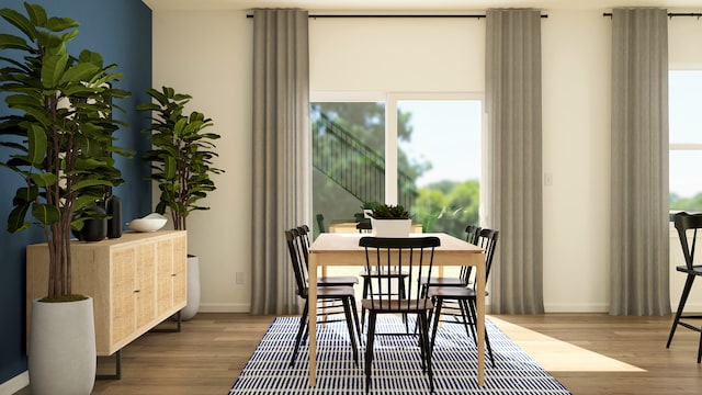 dining space featuring wood finished floors and baseboards