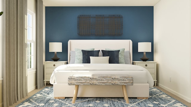 carpeted bedroom featuring multiple windows and baseboards