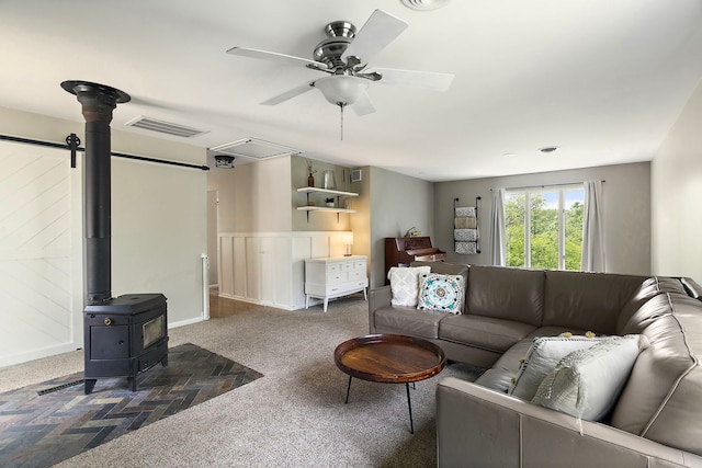 543 Blackhawk Dr, Lake In The Hills, IL 60156 - carpeted living area with a wood stove, a ceiling fan, and attic access