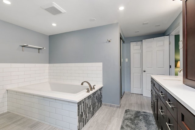 543 Blackhawk Dr, Lake In The Hills, IL 60156 - full bath featuring a garden tub, vanity, recessed lighting, baseboards, and wood finished floors