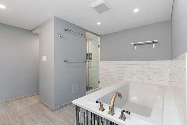 543 Blackhawk Dr, Lake In The Hills, IL 60156 - bathroom with a garden tub, recessed lighting, wood finished floors, a shower, and baseboards