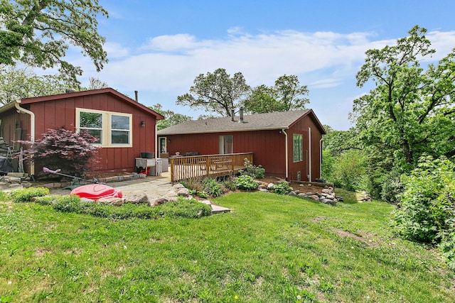 543 Blackhawk Dr, Lake In The Hills, IL 60156 - rear view of house featuring a wooden deck and a lawn