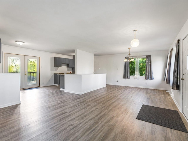 1659 Larchmont Rd, Davis, IL 61019 - unfurnished living room featuring dark wood finished floors, baseboards, a chandelier, and french doors