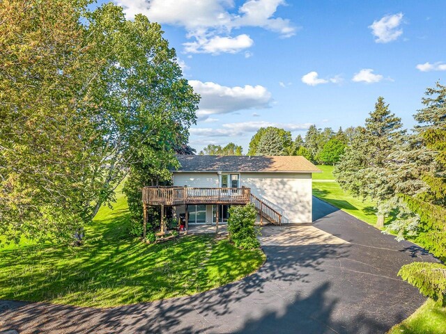 1659 Larchmont Rd, Davis, IL 61019 - view of front of home featuring a deck, a front lawn, a patio, driveway, and stairway