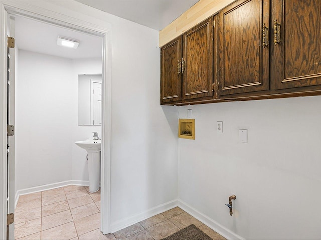 1659 Larchmont Rd, Davis, IL 61019 - laundry room with cabinet space, hookup for a washing machine, light tile patterned flooring, and baseboards