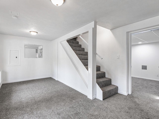 1659 Larchmont Rd, Davis, IL 61019 - basement with carpet floors, stairway, electric panel, baseboards, and a textured ceiling