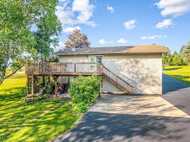 1659 Larchmont Rd, Davis, IL 61019 - view of front of home featuring a deck, stairs, and a front lawn