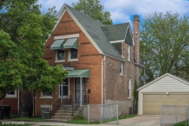 6945 S Eberhart Ave, Chicago, IL 60637 - english style home featuring brick siding, a chimney, an outbuilding, fence, and roof with shingles