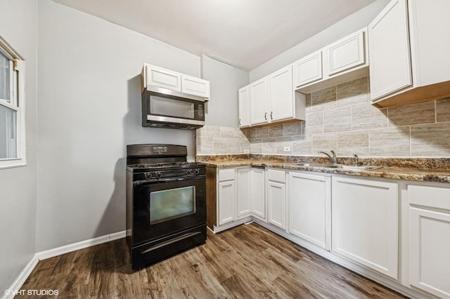 6945 S Eberhart Ave, Chicago, IL 60637 - kitchen with black gas range oven, stainless steel microwave, a sink, wood finished floors, and white cabinetry