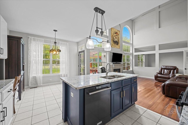 343 Diane Ct, Geneva, IL 60134 - kitchen with dishwashing machine, a sink, baseboards, and open floor plan