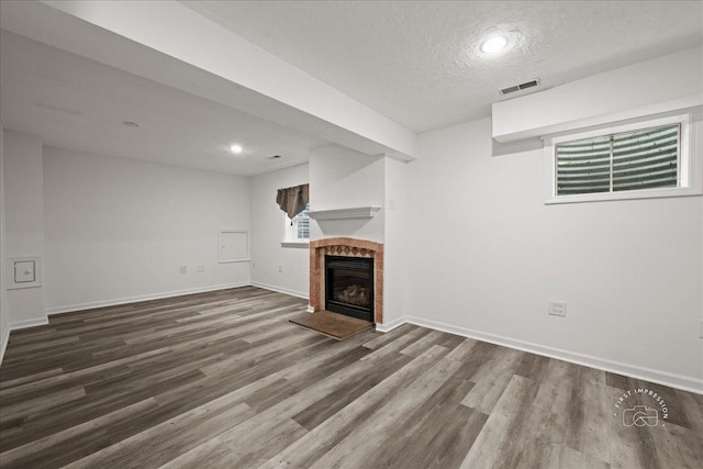 343 Diane Ct, Geneva, IL 60134 - unfurnished living room with wood finished floors, a fireplace, baseboards, a textured ceiling, and healthy amount of natural light