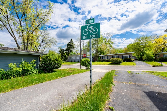 view of asphalt road with traffic signs