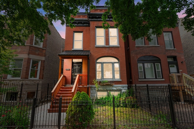 3230 W Fulton Blvd, Chicago, IL 60624 - multi unit property featuring brick siding, a fenced front yard, and a standing seam roof