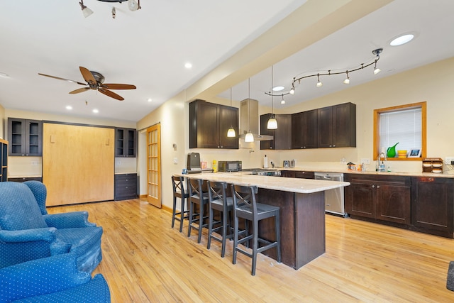 3230 W Fulton Blvd, Chicago, IL 60624 - kitchen with wall chimney exhaust hood, stainless steel dishwasher, open floor plan, a kitchen breakfast bar, and dark brown cabinetry