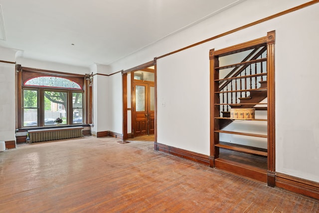 3230 W Fulton Blvd, Chicago, IL 60624 - empty room featuring radiator heating unit, baseboards, and stairs