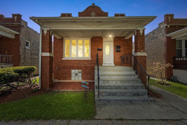 view of front of home with brick siding and covered porch